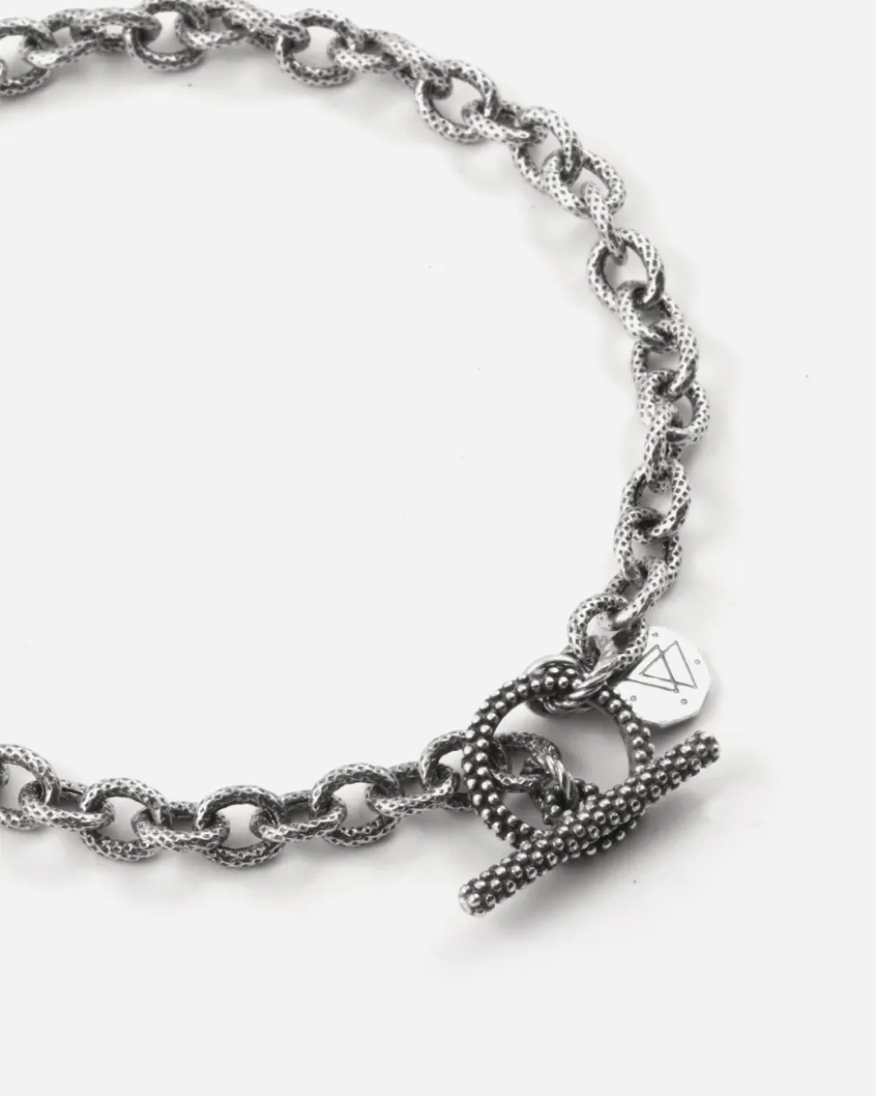 BRACCIALE CATENA RIGATA CON T-BAR PUNTINATA IN ARGENTO